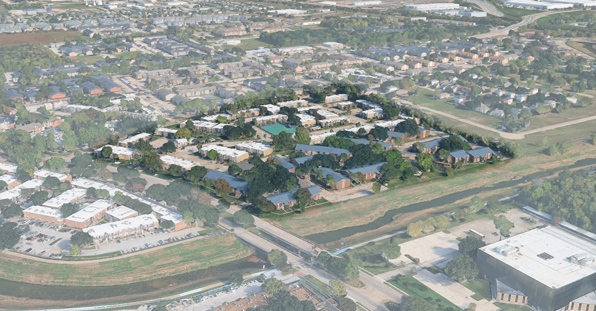 Aerial view of the Biscayne at Cityview apartment community surrounded by trees and nearby residential neighborhoods, with Greens Bayou visible along the bottom of the image.